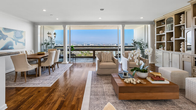 Chic living and dining area with panoramic city views and elegant decor